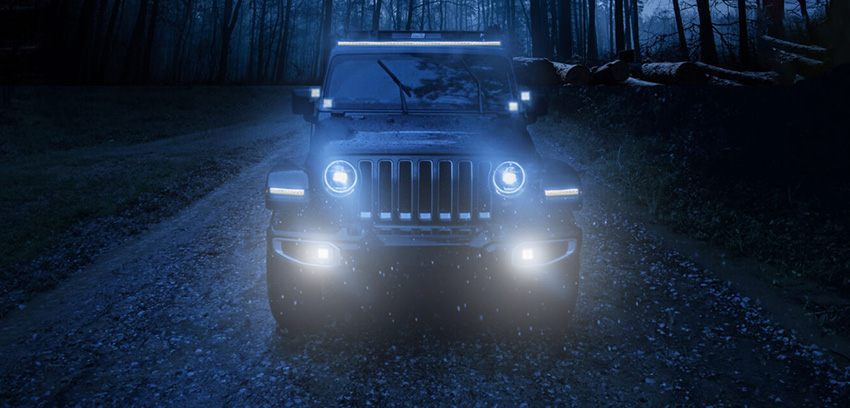 Black Magic Flush Mount Cube Flood Driving lights on bumper of Red Jeep Wrangler at Night
