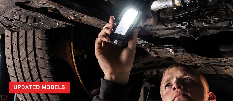 Techniciant inspecting underside of vehicle with Scangirp Uniform inspection lamp